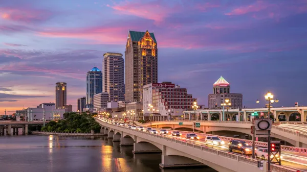 A vibrant skyline of downtown Tampa with cell tower signals overlaid, symbolizing seamless connectivity across the city's diverse landscape.