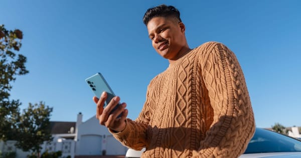 Man looking at his phone checking AT&T deals.
